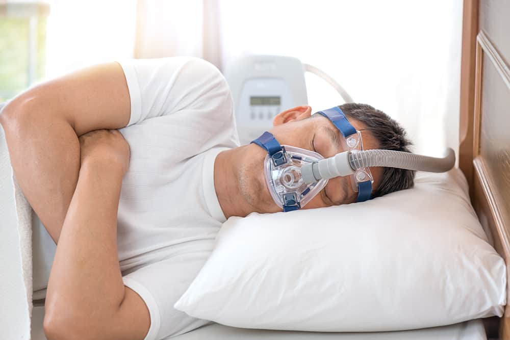man sleeping with cpap mask