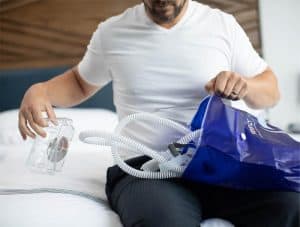 man packing the sleep8 cpap cleaner